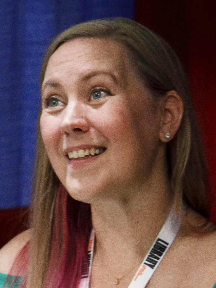 Rebecca Yarros signing copies of her books at a table at the 2024 Library of Congress National Book Festival